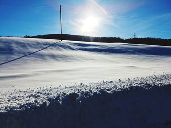 Scenic view of snow covered landscape against sky