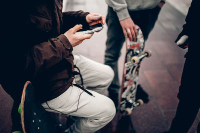 Midsection of man holding mobile phone