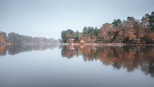 Scenic view of calm lake against sky during autumn