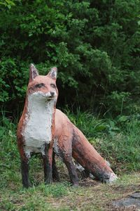 Fox sculpture against trees