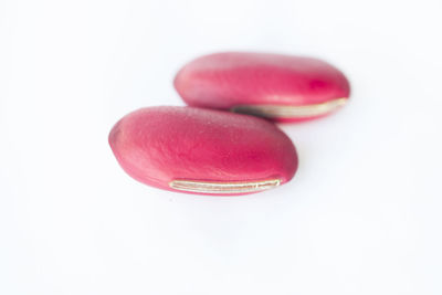 Close-up of pink over white background