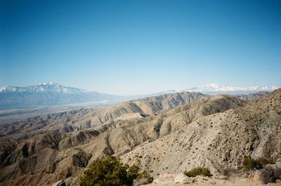 Scenic view of desert against clear blue sky