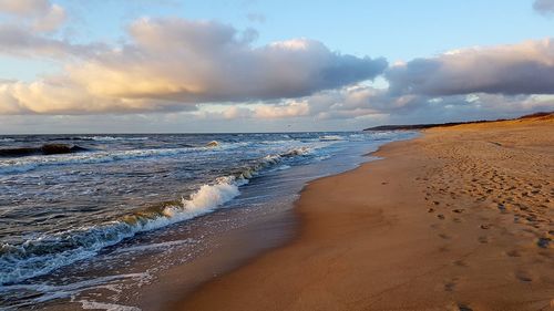 Scenic view of beach against sky during sunset