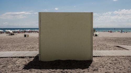 People on beach against sky