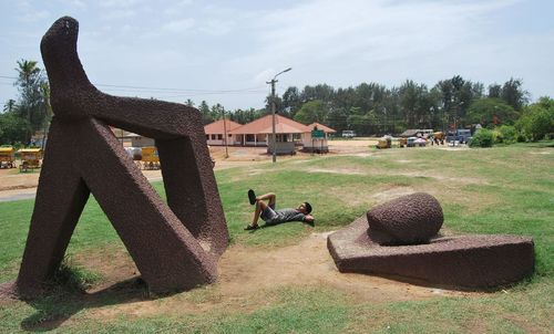 View of grassy field against cloudy sky