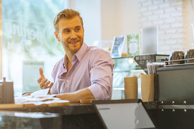 Owner looking away at cafe