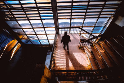 High angle view of silhouette woman on staircase