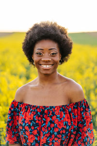 Portrait of smiling woman on flowering field