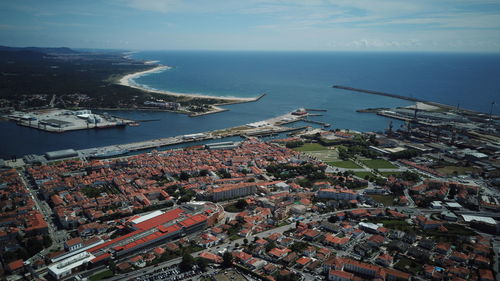 High angle view of buildings by sea against sky