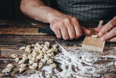 Midsection of man preparing food on table