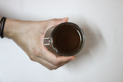 Directly above shot of hand holding coffee cup