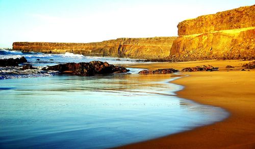 Scenic view of beach against sky