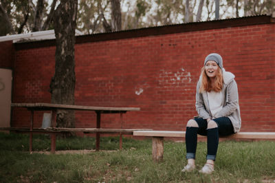 Portrait of smiling young woman sitting on seat