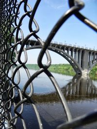 Close-up of chainlink fence against sky