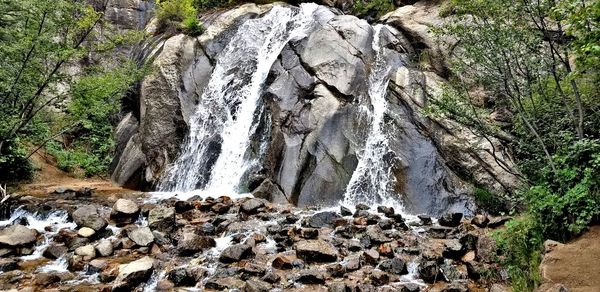 Panoramic view of waterfall in forest