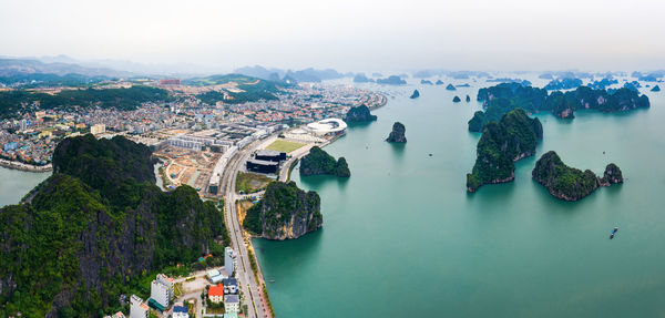 High angle view of cityscape by river against sky