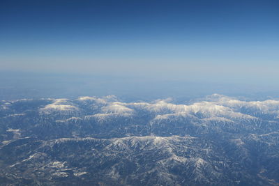 Aerial view of landscape against clear blue sky