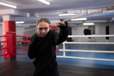 Strong woman doing shadow boxing on ring