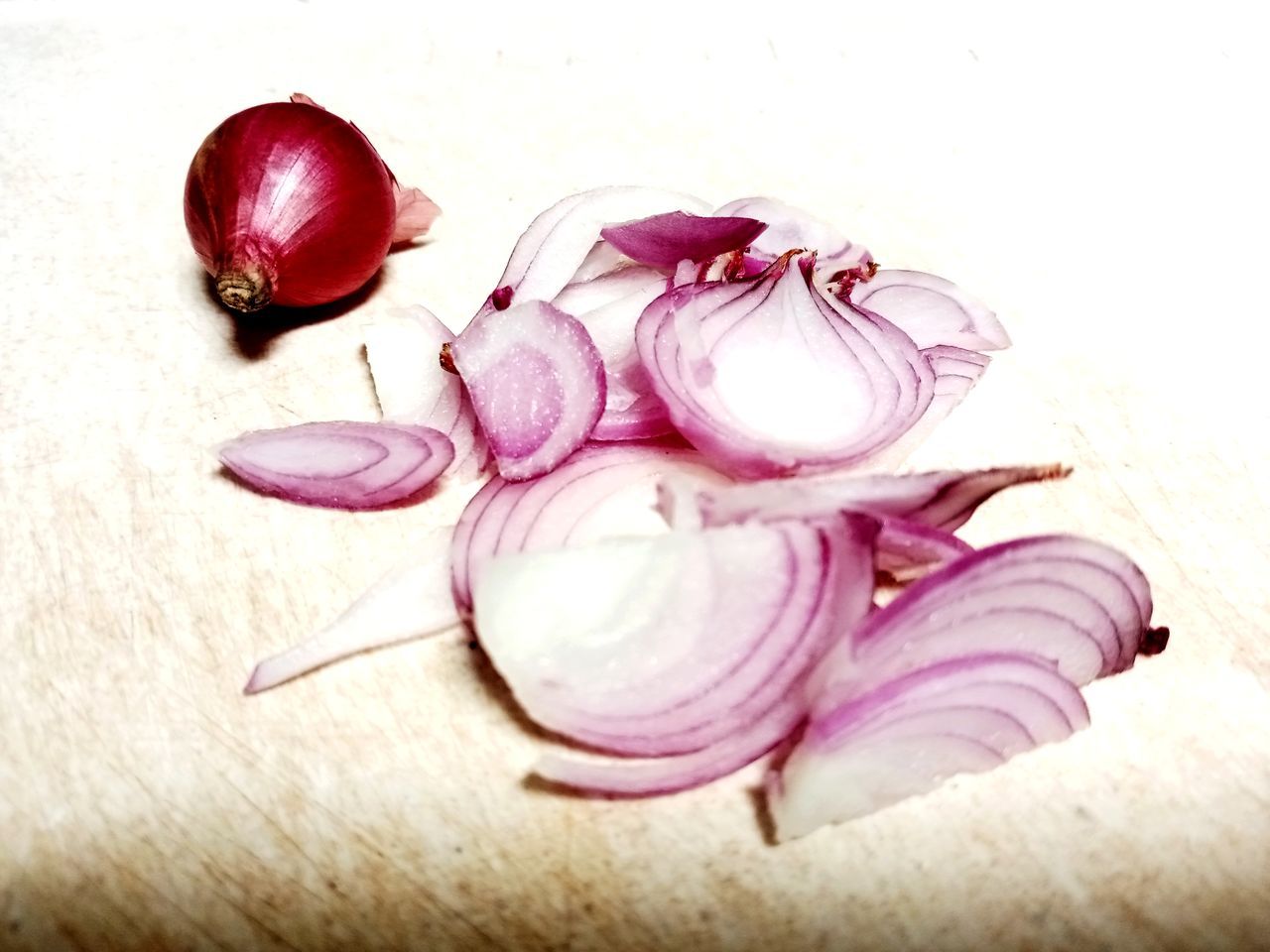 petal, food and drink, food, red onion, shallot, freshness, pink, healthy eating, onion, produce, wellbeing, flower, plant, purple, indoors, vegetable, still life, no people, close-up, ingredient, raw food, garlic, fruit, radish, table, studio shot, organic, high angle view, spanish onion