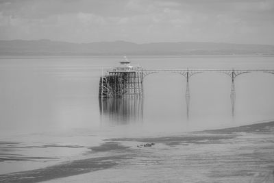 Panoramic photo of clevedon pier in somerset showing iron structure against blue sky