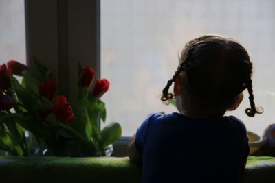 Rear view of boy on sofa at home