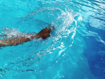 Hand splashing swimming in pool