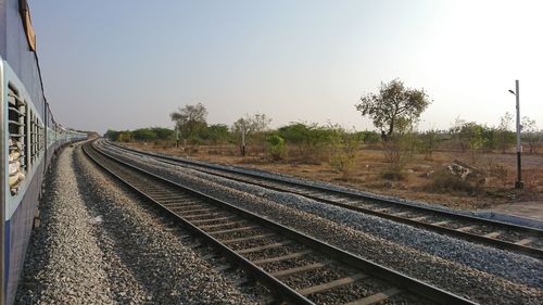 Railroad tracks against clear sky