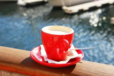 Close-up of coffee cup on wooden table