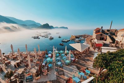 High angle view of townscape by sea against sky