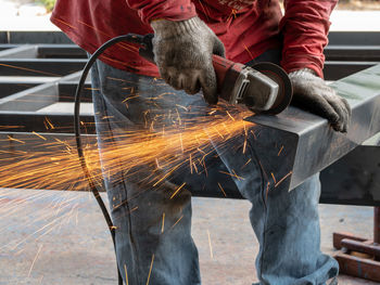 Low angle view of man working on metal