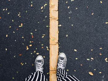 Low section of person standing on road