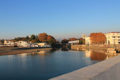 River by buildings against clear blue sky. sochi 