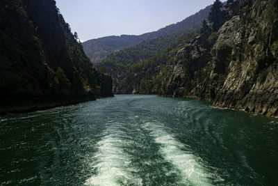 Scenic view of river amidst mountains against sky
