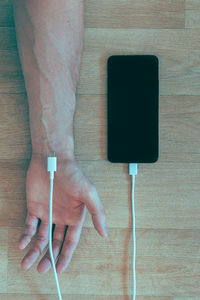Smart phone charging by hand of man