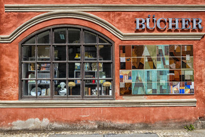 Reflection of building on glass window in restaurant
