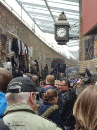 Rear view of people standing against buildings in city