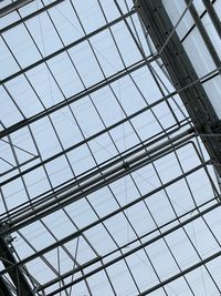 Low angle view of glass building against sky