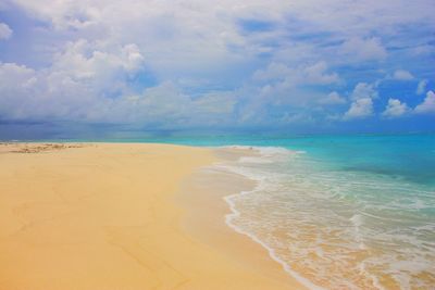 View of beach against cloudy sky