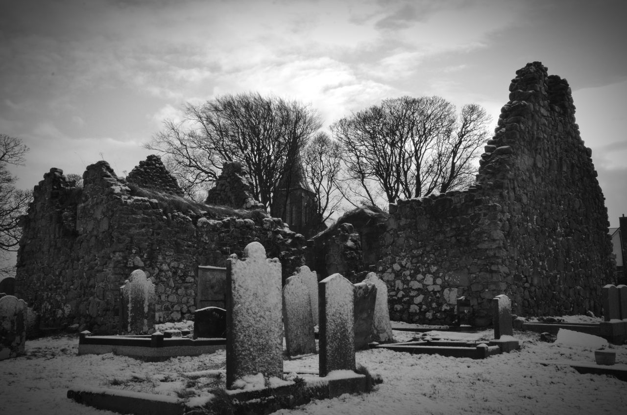 sky, tree, cloud - sky, built structure, old, old ruin, architecture, the past, cemetery, history, bare tree, tranquility, low angle view, damaged, death, building exterior, abandoned, cloud, nature, tombstone