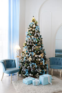 A beautiful blue living room decorated for christmas
