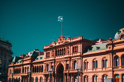 Low angle view of buildings against clear blue sky  argentina buenos aires casa rosada