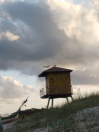 Low angle view of information sign against sky