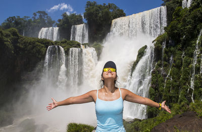 Woman posing in front of iguazu waterfalls