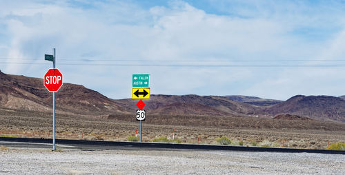 Road sign against sky