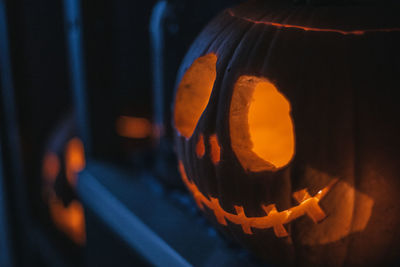 Close-up of illuminated pumpkin against black background