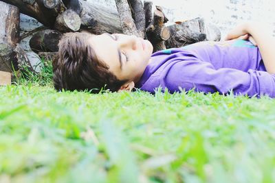 Boy lying on field at park