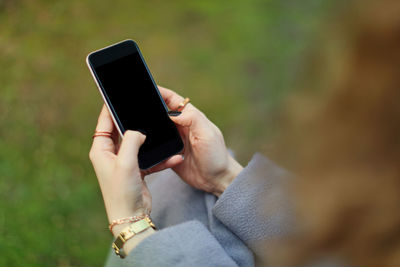 Midsection of man using mobile phone