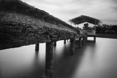 Bridge over lake against buildings