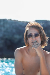 Close up portrait of man enjoying freedom on luxury yacht deck relaxing on boat summer vacation.