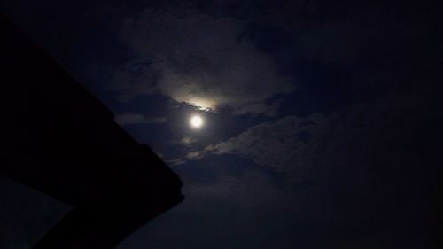 Low angle view of silhouette moon against sky at night